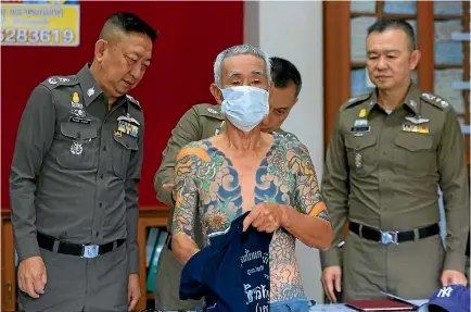  ?? PHOTO: AP ?? Fugitive Japanese gangster Shigeharu Shirai displays his tattoos during a media conference at the police station in Lopburi, central Thailand.
