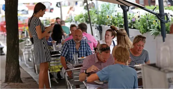  ?? Matt stone pHotos / Herald staff file ?? MAKING IT WORK: Diners enjoy outdoor seating at Carmelina’s in the North End on July 21. Below, diners eat at Stephanie's On Newbury on May 3.