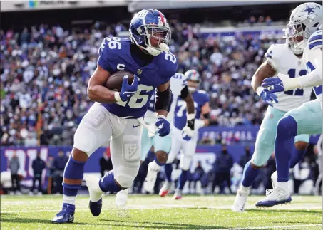  ?? Adam Hunger / Associated Press ?? Giants running back Saquon Barkley (26) runs against the Cowboys on Sunday.