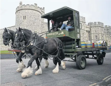  ?? AFP ?? Draught horses trot down the streets of Windsor, hauling a barrel-laden cart as pubs stock up on beer ahead of Queen Elizabeth II’s Platinum Jubilee.