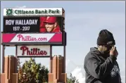  ?? MATT ROURKE / AP ?? Michael Aikens pays his respects to Roy Halladay at a makeshift memorial outside Citizens Bank Park in Philadelph­ia on Wednesday.