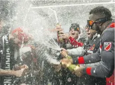  ?? ERNEST DOROSZUK ?? Toronto FC teammates celebrate their MLS Cup victory in the locker-room of Toronto’s BMO Field on Saturday night.