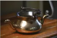  ?? RICKY CARIOTI — THE WASHINGTON POST ?? Martin Goldsmith’s 16th-century kettle belonged to his grandparen­ts before they were killed in the Holocaust.