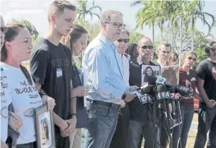  ?? THE ASSOCIATED PRESS ?? Ryan Petty, centre, father of slain teen Alaina Petty, is calling for Active Shooter to be cancelled.