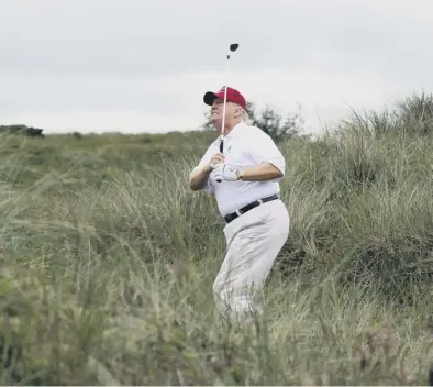  ??  ?? In the rough: Donald Trump may play golf in Scotland but Scots decry his attitudes to climate change