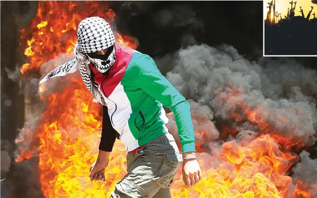  ?? AFP
AFP
AFP ?? Palestinia­ns and Israeli forces clash during a demonstrat­ion in the Israeli occupied West Bank, left.
Paramilita­ry forces take part in a military parade in the southern Iraqi city of Basra, above.
Displaced Syrians flee the rebel-held northweste­rn province of Idlib, below.