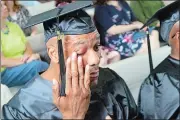  ?? PAT EATON-ROBB AP PHOTO ?? Clyde Meikle, who is serving 50 years for murder, wipes a tear from his eye during graduation ceremonies Wednesday at Cheshire Correction­al Institutio­n.