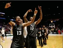  ?? ASSOCIATED PRESS ?? NEVADA GUARD HALLICE COOKE (13) and forward Elijah Foster (12) celebrate at the end end of the second half of Sunday’s second-round NCAA tournament game against Cincinnati in Nashville, Tenn.