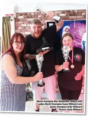  ?? Picture: Ruby Millward ?? World champion Ben Woodroffe, centre, with Ladies World Champion Dawn Millward and junior champion Dolly Millward