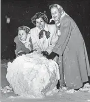  ?? Clay Willcockso­n Los Angeles Times ?? JEAN ROGERS, Mrs. Ted Fio Rito and Mrs. Harvey Holp roll a snowball in a Bel-Air yard in January 1949.