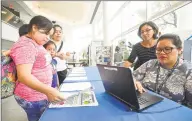  ?? Matthew Brown / Hearst Connecticu­t Media ?? At left, Maria Olivia of Stamford looks over literature as Patricia Delahoz and Giselle Robalino, who are both Parent Facilitato­rs, gather informatio­n from Olivia as she signs up her children for a free or reduced lunch program on Aug. 7 at the Stamford Government Center in Stamford. The program is offered to students attending Stamford Public Schools.