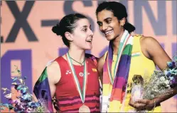  ?? Praveen Khanna ?? Marin and Sindhu share a light moment on the podium.