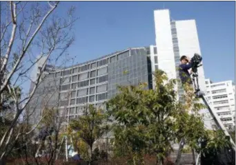  ?? SHUJI KAJIYAMA — THE ASSOCIATED PRESS FILE ?? In this Friday file photo, a cameraman on a ladder stands by outside Tokyo Detention Center, where former Nissan chairman Carlos Ghosn and former another executive Greg Kelly are being detained, in Tokyo.