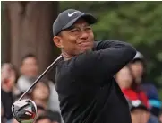  ??  ?? Tiger Woods of the United States watches his tee shot on the 11th hole in Tokyo on Thursday.