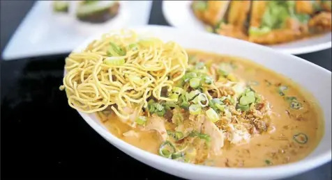  ?? Lake Fong/Post-Gazette ?? Egg noodles with chicken, bean sprouts, pickled mustard greens and crispy shallots in a yellow curry coconut sauce is available at Noodlehead in Shadyside.