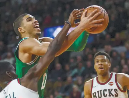  ?? AP FOTO / TOM LYNN ?? Boston Celtics’ Jayson Tatum drives past Milwaukee Bucks’ Tony Snell during the second half of their NBA game in Milwaukee.