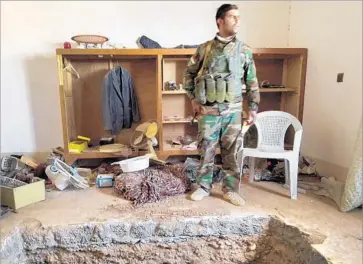  ?? Molly Hennessy-Fiske Los Angeles Times ?? IBRAHIM HUSSEIN, a Kurdish fighter, near the tunnel that led to a militant leader’s hide-out in Shakoli, Iraq. The well-appointed undergroun­d quarters had wood paneling, bedding, toiletries, electricit­y and books.