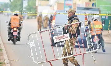  ??  ?? Burkina Faso police establish a barrier in Ouagadougo­u, following a deadly attack on a restaurant. — AFP photo