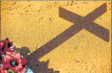  ?? AFP ?? The shadow of a cross from a Covid-19 victim’s grave is seen at the Nossa Senhora Aparecida cemetery in Manaus, Brazil.