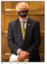  ?? (Arkansas Democrat-Gazette/ Stephen Swofford) ?? Gov. Asa Hutchinson wears a mask given to him by the Ozark Hillbillie­s golf team as he waits to speak at his daily briefing Tuesday.