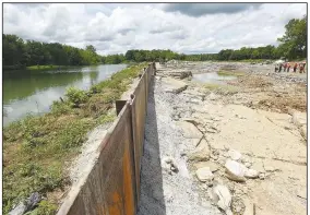  ?? (NWA Democrat-Gazette/Flip Putthoff) ?? The main channel of the Illinois River is seen Tuesday on the left of a steel barrier while the channel that will be the whitewater park is at right near Watts, Okla.