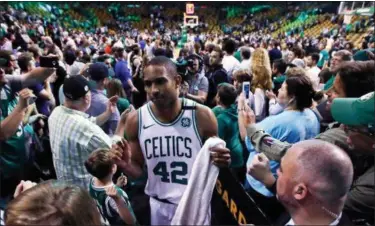  ?? CHARLES KRUPA — THE ASSOCIATED PRESS ?? Celtics forward Al Horford wades through a crowd after Boston defeated Milwaukee on April 28.