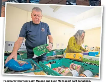  ?? ?? Foodbank volunteers Jim Malone and Lynn McTaggart sort donations.