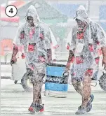  ?? Picture: JONACANI LALAKOBAU ?? 4. Officials brave the rain to provide drinks for the teams on the last day of the tournament. 4