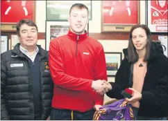  ?? ?? Thomas O’Donnell (left) representi­ng sponsors T&A, and six time All-Star Orla Cotter present a Munster medal, All-Ireland runners-up medal and All-Ireland jersey to fullback and joint captain, Eoghan O’Riordan, honouring the Premier Junior hurlers at a recent function in the clubrooms.