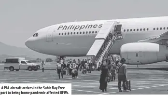  ??  ?? a pal aircraft arrives in the subic Bay freeport to being home pandemic-affected ofws.