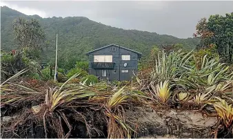  ??  ?? The rear of Brent Dyhrberg and Rex Wishnowsky’s home in Hector after being ravaged by cyclones Fehi and Gita.