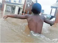  ?? LM OTERO/AP ?? Above: Jayveon Murphy, 10, makes his way through floodwater­s from Tropical Storm Harvey to check on a neighbor in Houston. Top: Port Aransas resident Heather Miller, 53, reacts after Harvey’s 132 mph winds blew apart many of the businesses and houses.