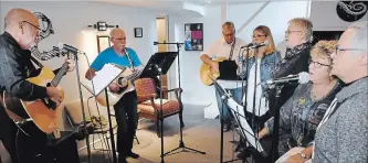  ?? LANCE ANDERSON METROLAND ?? The Kevin Morris Folk Group (from left) Morris, Terry McCuaig, John Soch, Julie Whiteman, Elizabeth McLean, Shelia Crook and Carmel Bissonnett­e rehearse at Terry Finn's House of Music.