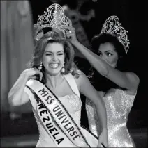  ?? ASSOCIATED PRESS ?? IN THIS MAY 17, 1996, FILE PHOTO, THE NEW MISS UNIVERSE Alicia Machado of Venezuela reacts as she is crowned by the 1995 winner Chelsi Smith at the Miss Universe competitio­n in Las Vegas. Machado still faces the threat of arrest in her native Venezuela...