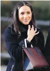  ?? AP ?? Meghan Markle’s long navy double-breasted wool coat was designed by Montreal-based outerwear label Mackage.