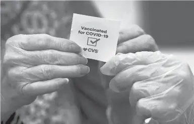  ?? MARCIO JOSE SANCHEZ/AP ?? A patient gets a sticker after a shot of the Moderna vaccine in March at a CVS Pharmacy branch in Los Angeles. A flurry of employers are requiring workers to get vaccinated after the federal government gave full approval to Pfizer’s vaccine.