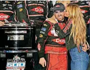  ?? PHOTO] [AP ?? Austin Dillon gets a kiss from his wife, Whitney, in Victory lane after winning the NASCAR Daytona 500 Sunday at Daytona Internatio­nal Speedway in Daytona Beach, Fla.