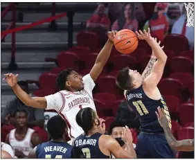  ?? (NWA Democrat-Gazette/J.T. Wampler) ?? Arkansas guard JD Notae blocks a shot by Oral Roberts’ Carlos Jurgens during Sunday’s game at Walton Arena in Fayettevil­le. Notae finished with 15 points, 5 rebounds, 3 assists and 3 blocks. More photos available at arkansason­line.com/1221uaoru.