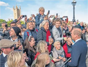  ?? ?? King Charles III, far left, and the Prince of Wales, left, chat to members of the public in the queue to pay their respects to the Queen along the South Bank, near Lambeth Bridge in London