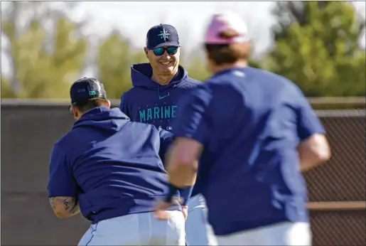  ?? AP 2023 ?? Mariners manager Scott Servais watches players warmup during spring training Feb. 18 in Peoria, Arizona. To many, such as Servais, the Automated Ball-strike System has begun to feel inevitable. Umpires have already agreed to allow it at the major league level when it is ready.