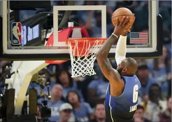  ?? RICK BOWMER – THE ASSOCIATED PRESS ?? The Lakers’ LeBron James slams down a dunk during the first half of Sunday’s NBA All-Star Game in Salt Lake City.