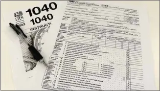  ?? ?? An Internal Revenue Service 2023 1040 tax form and instructio­ns are shown on Jan. 26, 2024 in New York. It’s tax season in the U.S., and for many people, filing tax returns can be a daunting task that’s often left until the last minute. (AP)