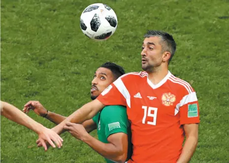  ?? AP PHOTO ?? Russia’s Alexander Samedov, right, battles with Saudi Arabia’s Salem Aldawsari during a Group A match that opened the 2018 World Cup in Moscow, Russia, on Thursday. The home side won 5-0.