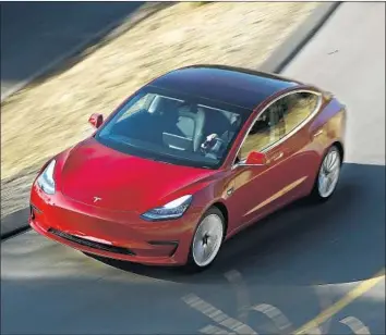  ?? Mel Melcon Los Angeles Times ?? TESLA is currently producing only loaded Model 3s; the entry-level cars aren’t being built yet. Inside, all the vehicle informatio­n normally relayed through dashboard dials is contained on a 15-inch touch screen.