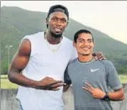  ??  ?? Nisar Ahmed (right) with Usain Bolt in Jamaica.