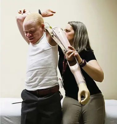  ?? — Photos: AP ?? Jennifer Stieber, (right), fits Festo with a new prosthetic limb to accomodate his growing body.