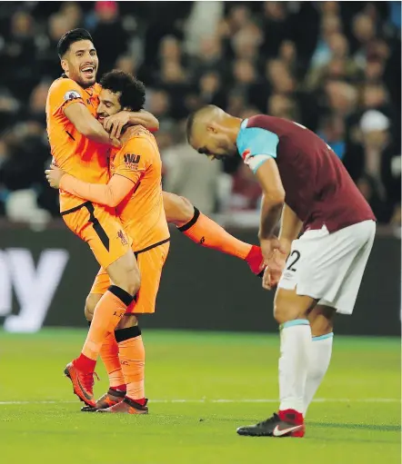  ?? — THE ASSOCIATED PRESS ?? Liverpool’s Mohamed Salah celebrates with teammate Emre Can after scoring his team’s fourth goal in a 4-1 victory over West Ham Saturday at London’s Olympic Stadium.