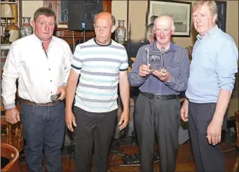  ??  ?? Gerry Perry, Sean Cunningham,of Ballinlack Community Park Committee, Michael McDonnell , holding glass item, presented to him by on the right Tom McGettrick of Sligo Leader Partnershi­p . ( Pic: Tom Callanan .)