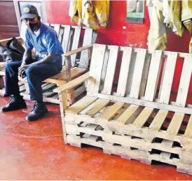  ?? FILE ?? A firefighte­r at the Ocho Rios Fire Station sits on one of several benches that have been made by the firemen.