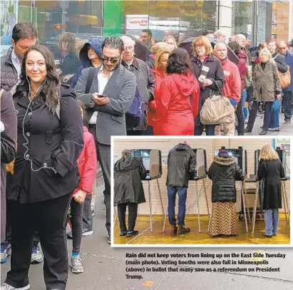  ??  ?? Rain did not voters from lining up on the East Side Tuesday(main photo). Voting booths were also full in Minneapoli­s (above) in ballot that many saw as a referendum on President Trump. LUIZ C. RIBEIRO/FOR NEW YORK DAILY NEWS